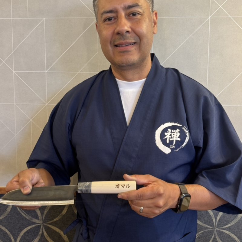 Omar, owner of Accusharp Cutlery Service, holding a Japanese knife